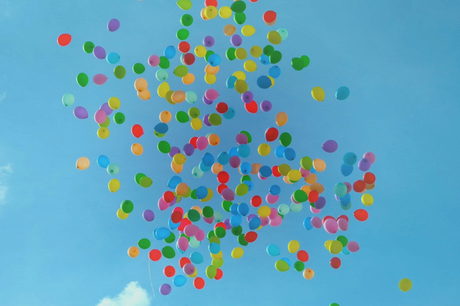 coloured balloons in bright blue sky